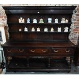 An 18th century oak three drawer dresser, with associated rack (reduced in height), with planked pot