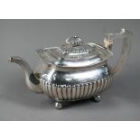 A George III silver half reeded oblong teapot with ivory insulators, on bun feet, Solomon Hougham (