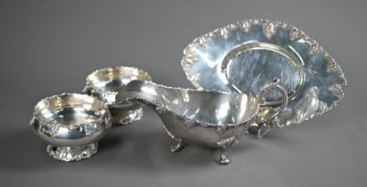 A white metal sauce boat on stand, to/w a matching pair of small bowls, stamped 'Silver' (4 pieces -