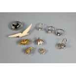 Five various stone set rings, including one diamond, a lucite oval brooch featuring reverse carved