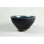 A Chinese Jianyao 'oil spot' bowl in the Song Dynasty style, covered in a thick unctuous black glaze