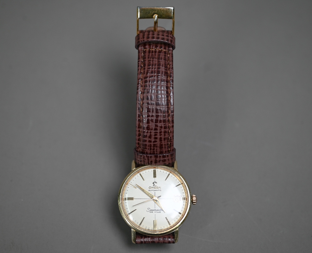 A gold plated Omega automatic Seamaster De Ville wrist watch, the champagne dial with gilt batons