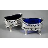 Hester Bateman - a pair of oval pierced silver open salts with blue glass liners, on fluted feet,