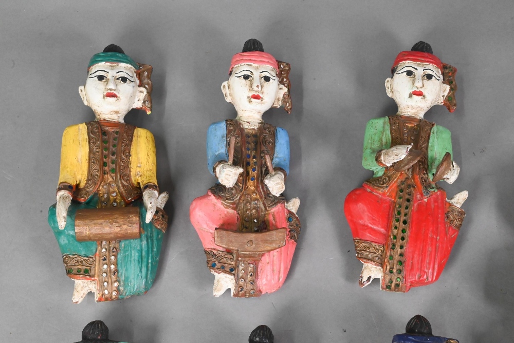 A set of seven vintage polychrome Burmese temple musician wall plaques, carved hardwood with - Image 4 of 9