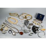A collection of vintage and later costume jewellery including three gilt metal bangles, brooches,