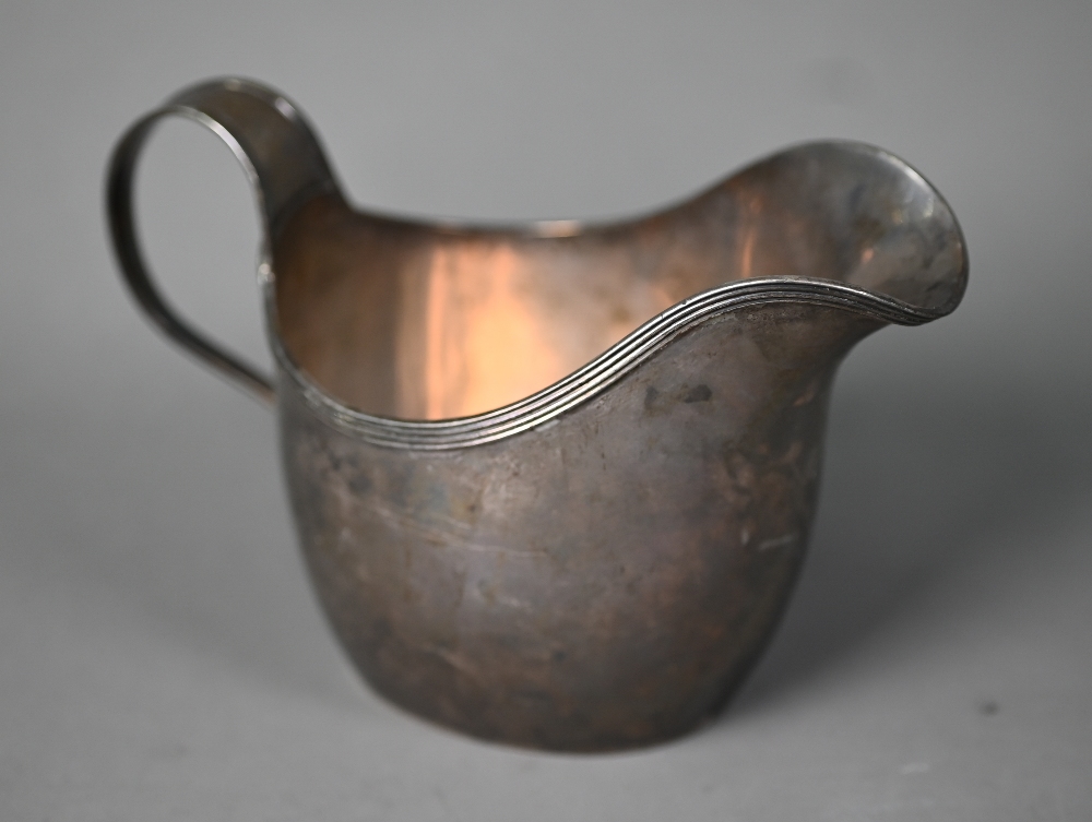 Paul Storr: a George III helmet cream jug with reeded rim and scrolling strap handle, London 1812,