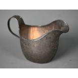 Paul Storr: a George III helmet cream jug with reeded rim and scrolling strap handle, London 1812,