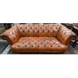 A large contemporary antiqued buttoned brown leather Chesterfield style sofa and matching