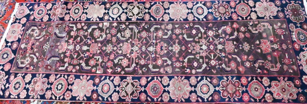 A Persian blue ground Lilihan runner, the repeating geometric design on brown ground, 296 cm x 104