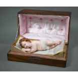A 19th century Continental musical Automaton-wax sleeping infant - wakes up and moves its head as