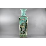 A late 19th or early 20th century Chinese famille verte vase with flared cylindrical neck rising