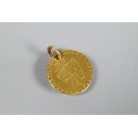 A George III gold Guinea dated 1789, drilled with bolt ring attached, approx 8.8g all in