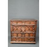 A Jacobean oak chest of four long irregularly graduated drawers, with applied geometric mouldings