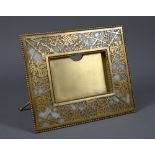 Tiffany Studios, New York, a gilt brass and mottled opaque glass panelled strut frame in the pine