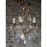 A gilt brass and crystal glass hung five branch electrolier, approx. 40 cm dia. x 60 cm h