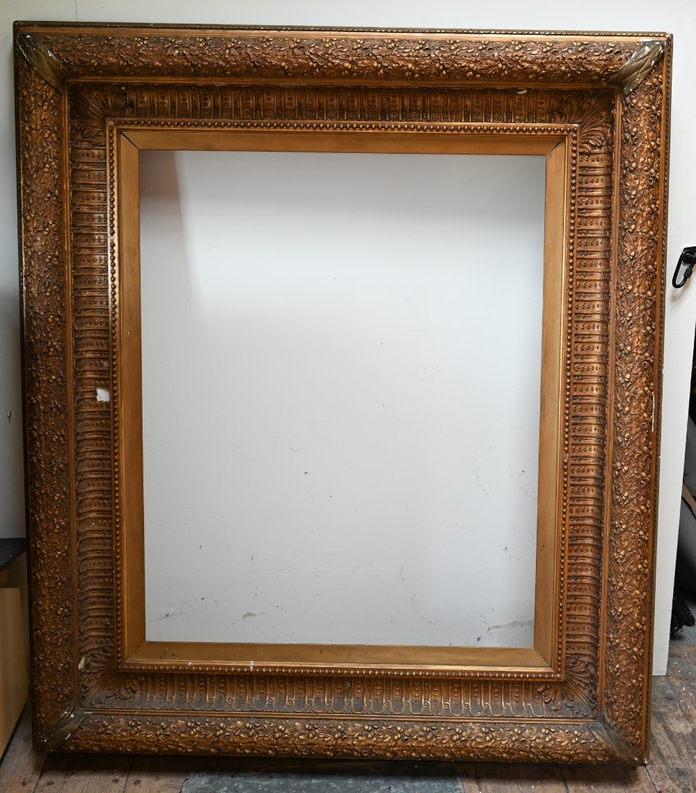 A large decorative 19th century picture frame with well-detailed mouldings depicting oak leaves