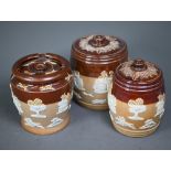 Two Victorian Royal Doulton stoneware tobacco barrels with bucolic scenes and a tobacco jar with