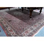 A Persian Bidjar red ground carpet, centred by a diamond floral lozenge, 335 cm x 247 cm good even