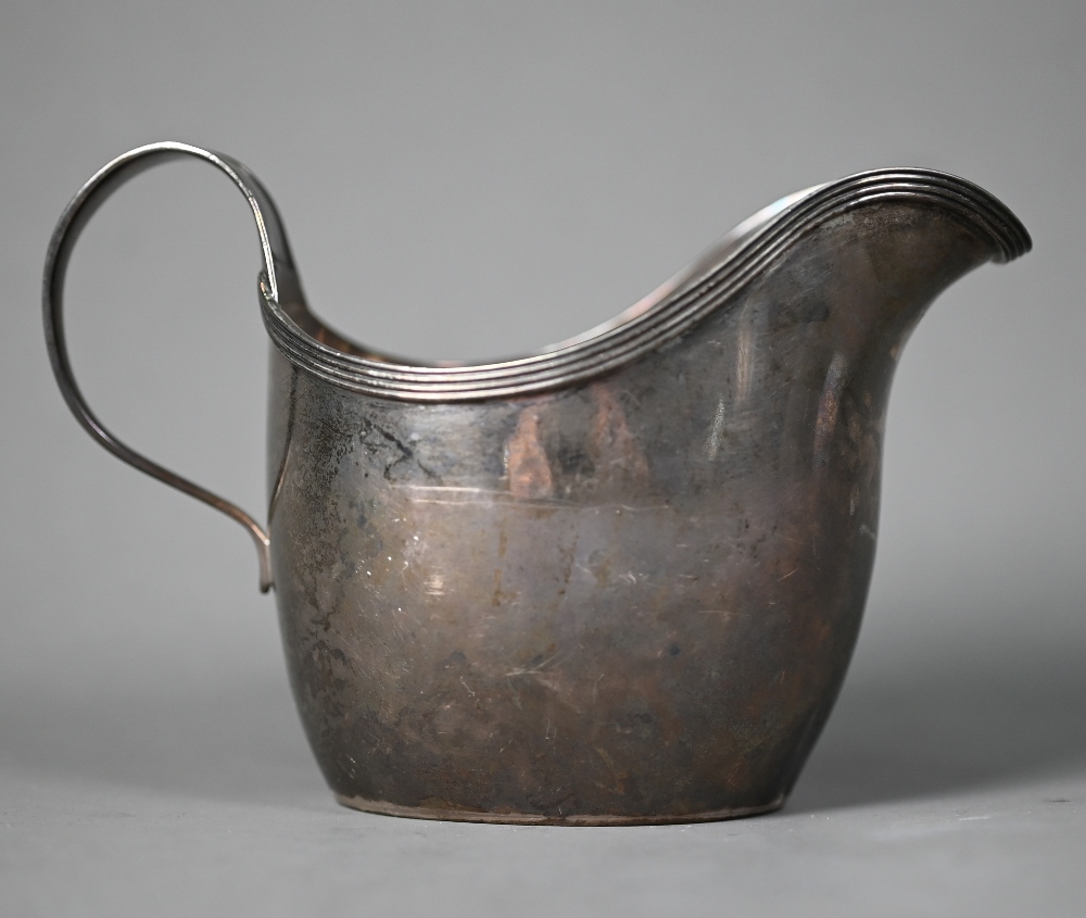 Paul Storr: a George III helmet cream jug with reeded rim and scrolling strap handle, London 1812, - Image 2 of 6