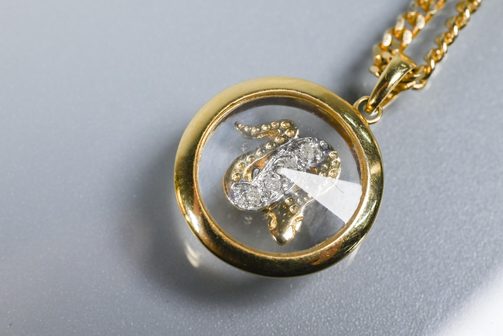 A Chopard-style 'Happy' snake pendant with rotating diamond-set serpent within, yellow metal stamped - Image 3 of 5