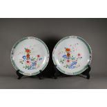 A pair of 18th century famille rose shallow bowls, painted with floral designs in polychrome