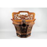 A Chinese stained hardwood water bucket of tapering octagonal form with floral and foliate fret-