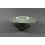 A Chinese Song style celadon lotus bowl, evenly covered with an opaque sage green glaze, the