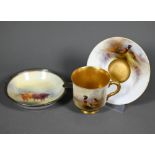 A Royal Worcester cabinet coffee cup and saucer with gilt interior, painted with pheasants by