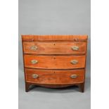 A Victorian mahogany bow-fronted chest of three drawers beneath a full width slide, raised on shaped