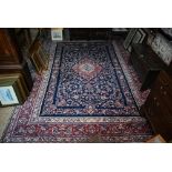 A fine Persian hand-made Tabriz carpet, the blue ground centred by a medallion, 368 cm x 265 cm good