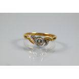 A single stone diamond ring, the collet set diamond in platinum and 18ct yellow gold setting, size P