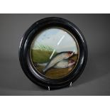 A 19th century reverse-painted on glass picture of two fish on a river-bank, 18 cm diameter in