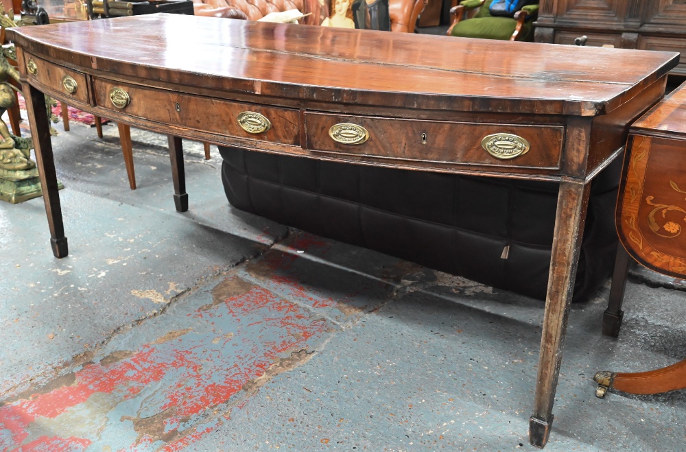 A Victorian mahogany bow-fronted sideboard with three drawers, raised on square tapering legs to