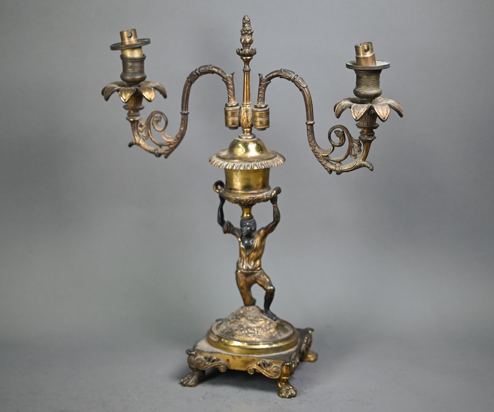 A 19th century ormolu and bronze candelabra, the twin branches raised by a kneeling blackamoor, 39