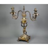 A 19th century ormolu and bronze candelabra, the twin branches raised by a kneeling blackamoor, 39