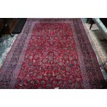 A fine old Persian hand-made Kashan carpet, the red ground with repeating linked garden vine design,