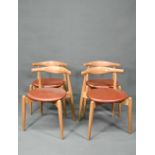 Carl Hansen & Son, a contemporary set of four CH20 dining chairs, oak framed with leather seats,