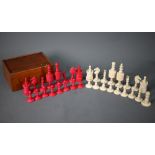 An antique turned and dyed bone chess set, King 9 cm, in mahogany box with sliding cover