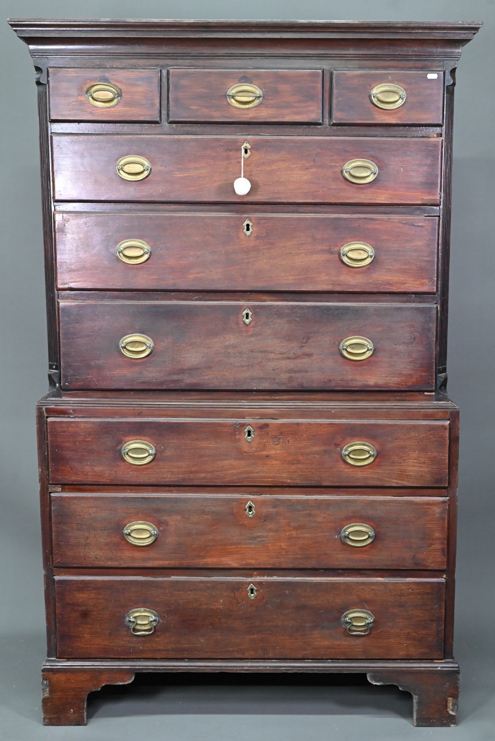 A George III mahogany chest on chest of three short over three long graduated drawers flanked by