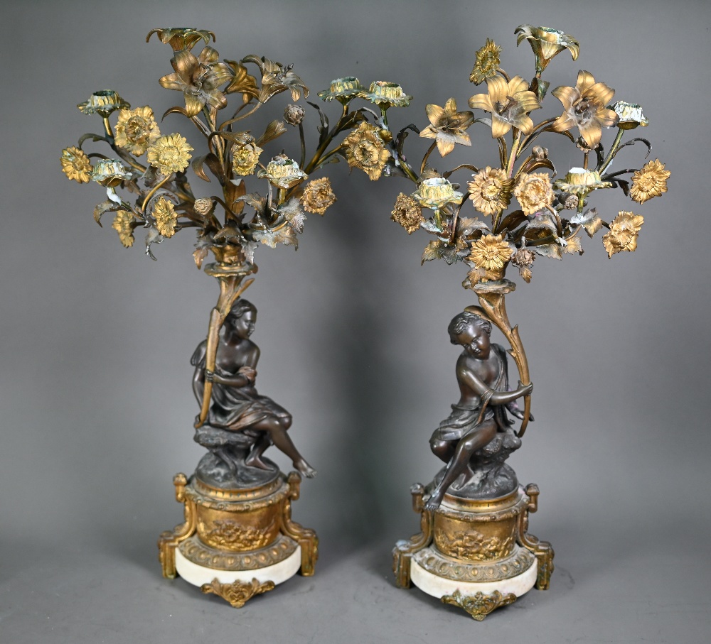 A good pair of French bronze, ormolu and marble six branch candelabra, the seated classical female