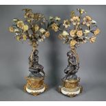 A good pair of French bronze, ormolu and marble six branch candelabra, the seated classical female