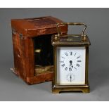 An antique brass carriage clock c/w leather travel case case