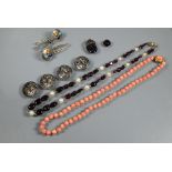 A graduated baroque garnet and pearl necklace, a coral bead necklace, four silver repoussé decorated