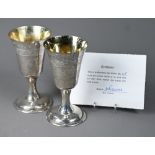 A pair of Lincoln Cathedral planished silver goblets with foliate engraving, limited edition nos.