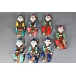A set of seven vintage polychrome Burmese temple musician wall plaques, carved hardwood with