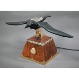 A brass, copper and leather 'Flying Mascot' automaton crow, probably designed as a shop window