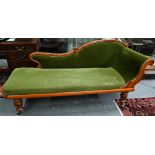 A late Victorian walnut framed single scroll end chaise, upholstered in green dralon, raised on