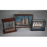 A Victorian waterline model of a two-masted fishing smack, in coastal diorama glazed case, 17 x 39