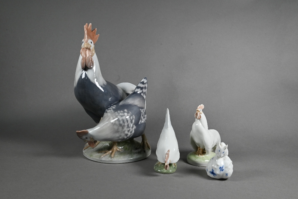 A Royal Copenhagen group, Cockerel and Hen 1094, 24 cm, to/w two small roosters 1126/27 and a blue