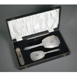 An engine-turned silver four-piece brush set, Birmingham 191961/62, in presentation case Handle of